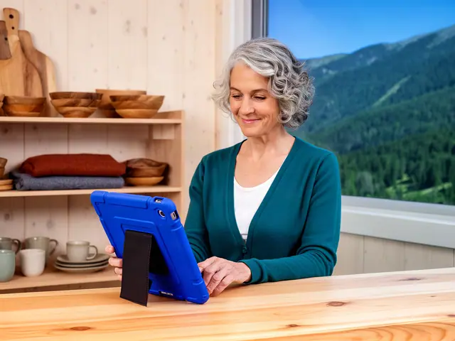 Owner of a handmade wooden home-goods shop checking inventory on a tablet behind the counter